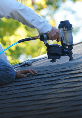 Zoomed in photo of a man bolting shingles onto a roof